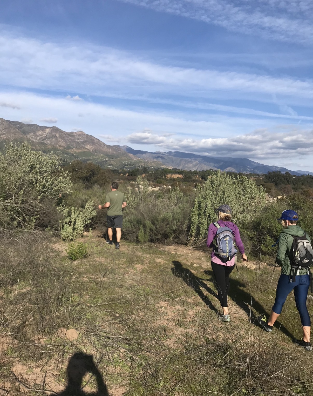 People enjoying a guided outdoor walk with mountain views